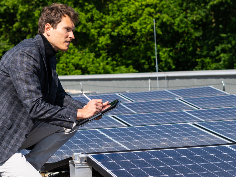 Mitarbeiter neben Photovoltaik-Anlage